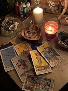 tarot cards and candles on a table