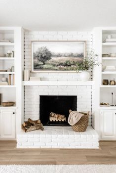 a living room with white brick fireplace and bookshelves