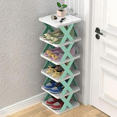 a white and green shoe rack next to a door