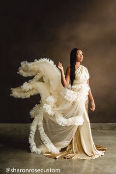 a woman in a white dress is holding a dragon