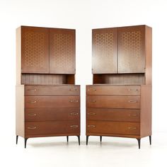 a pair of wooden dressers sitting next to each other