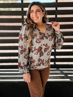 The Desert Blossom V-Neck Blouse brings a touch of Western-boho elegance to your wardrobe. With its delicate floral print and lightweight fabrication, this blouse is perfect for those days when you want to feel effortlessly chic. Featuring a flattering V-neckline, pinched shoulders, and elastic cuffs, it adds the perfect blend of feminine detail and casual comfort. The button-and-loop closure in the back creates a subtle keyhole design, making it a versatile top that pairs beautifully with jeans or skirts. Features: Floral print with a lightweight, breezy fabrication Flattering V-neckline and pinched shoulders for a feminine touch Elastic cuffs for added comfort and style Button-and-loop closure with a small keyhole at the back Perfect for layering or wearing on its own, making it ideal fo Flowy V-neck Blouse With Floral Print, Flowy V-neck Blouse For Fall, Fall Ditsy Floral Print V-neck Blouse, Fall V-neck Blouse With Ditsy Floral Print, Ditsy Floral Print V-neck Blouse For Fall, Bohemian V-neck Top With Ditsy Floral Print, V-neck Ditsy Floral Print Blouse For Fall, Fall Boho Print V-neck Tops, Fall Ditsy Floral Print V-neck Top