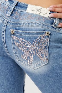 Low-rise, light-wash slim bootcut jeans- Butterfly design in pink and silver embroidery with matching yoke design- Mini silver rhinestone rivets throughout design- White leather logo brand patch- Rhinestone rivets- 5-pocket design- Slight fading Model is wearing size: 26Model Measurements:Height: 5'8"Bust: 35"Waist: 26"Hips: 39" Fabric Content: 52% Cotton, 27% Lyocell, 20% Polyester, 1% Elastane Care: Gentle machine wash inside-out with like colors in cold water. Tumble dry low. Style No. L9330S Luxury Faded Denim Flare Jeans, Cheap Vintage Cutoff Jeans, Star Boot Cut Jeans, Flare Jeans Print, Cheap Fitted Light Wash Flare Jeans, Luxury Faded Flare Jeans, Luxury Women's Jeans With Flap Pockets, Cheap Low-rise Women's Jeans, Western Cute Jeans