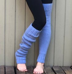 "These hand knit thigh high/over the knee leg warmers will soon be your favorite.  Wear them over tights, with your shorts or under track pants.  They are long enough to pull over the knee to mid thigh, or slouched down over cold feet.  Perfect accessory for the cold fall and winter months.    Wear them to yoga, Pilates or ballet class.   Hand knit from a very warm and cozy easy care 100% acrylic yarn in light blue .  Approximately 25\" long,  12\" at the knee and 8\" at ankle.  Measurements taken flat before stretching.  Model is 5' 9\" and wears a size 2-4.  Stretches to fit a wide variety of sizes.  Machine wash warm, tumble dry low.   Made in my pet free and smoke free home. Please read shop polices before making purchase. RETURNS ARE SUBJECT TO A 15% RESTOCKING FEE BUYERS ARE RESPONSI Cozy Fitted Solid Color Leggings, Fitted Cozy Leggings, Cozy Fitted Leggings For Winter, Knitted Stretch Winter Bottoms, Knitted Stretch Bottoms For Winter, Winter Stretch Knitted Bottoms, Fitted Knitted Bottoms For Fall, Stretch Knitted Bottoms For Winter, Cozy Stretch Knitted Bottoms