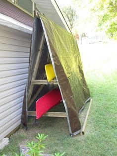 an open door on the side of a house that is covered with a tarp