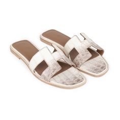 This pair of Oran Sandals are in Himalaya niloticus crocodile with tonal stitching and feature the iconic H crossover strap. Origin: ItalyCondition: Pristine; new or never Accompanied by: Hermes box, dustbags, carebook, CITES and ribbonSize: 38.5 EU White Gucci Espadrilles For Women, Women's White Gucci Espadrilles, Hermes Flat Sandals, Hermes Oran Sandals Gray, Hermes Flats, Designer Things, Hermes Oran Sandals, Classy Shoes, Hermes Oran