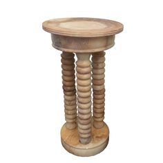 a small wooden stool with spiral legs and wood posts on the top, against a white background