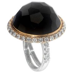 Zorab captures simplicity, elegance, and style with his Multi-Faceted 43.57 Carat Black Spinel dome shaped cocktail ring. The epic bombe center stone's richness is amplified by 1.22 carats of white diamonds circling the rim and extended to each side of the 18 Karat Gold and Palladium. This item has a serial number and bears the stamp of authenticity from Zorab Creation