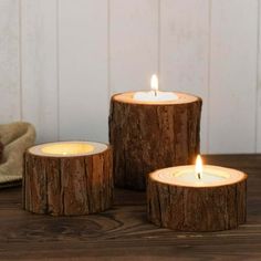 three wooden candles sitting on top of a table