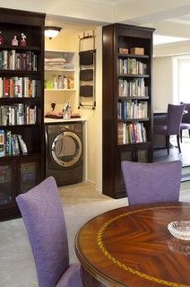 a laundry room with bookshelves, washer and dryer