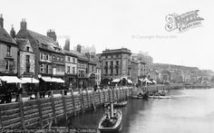 an old black and white photo of boats on the water in front of some buildings