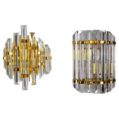 two wall lights made out of glass and gold