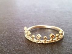 a gold crown ring sitting on top of a table