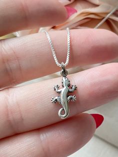 Please Read   Photos are enlarged to show detail. Please read the measurement in the description. Matching Earrings Here: https://www.etsy.com/listing/1689905301/sterling-silver-gecko-lever-back ☑️ The charm is .925 Sterling Silver and measures approximately 21x9mm. CHAINS: ☑️ The chains and components are .925 Sterling Silver. ☑️ The Satellite chain is 1mm thick with a 2mm ball. ☑️ The Staple chain is 2mm thick. ☑️ The Box chain is 1mm thick. ☑️ The Rope chain is 1.1mm thick. ❤️ Follow us on In The Satellite, Jewelry Chain, Waterproof Jewelry, Dream Jewelry, Gecko, Magnetic Clasp, Box Chain, Rope Chain, Matching Earrings