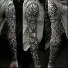 a man's full sleeve with an owl and flower tattoo design on his arm