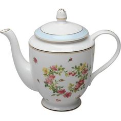 a tea pot with flowers painted on it