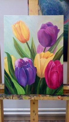 an easel with a painting of tulips on it