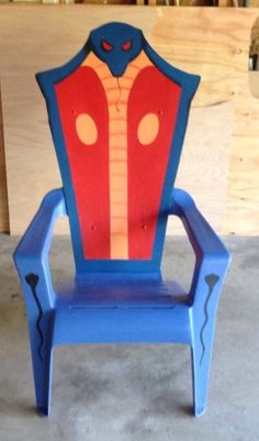 a blue and red chair sitting on top of a cement floor