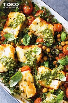 a casserole dish filled with meat, vegetables and pesto