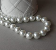 Chunky White Pearl Necklace, Big Pearl Necklace, Classic Pearl Necklace, Gift for Her  A very chunky pearl necklace made with highly reflective glass pearls.  Available in white or black so choose your favorite one at checkout.  This large pearl necklace is fun and makes a huge statement.  The 16mm pearls are very luminous, and that's a good thing since we all know pearls reflect light back up to your face.  And remember - light makes us all look younger!   Equally at home at the office, for a night out, or with your favorite jeans and tee shirt.   These pearls are large so you may need to order a longer size than normal.  The large size of these pearls makes the necklace wear and feel shorter than usual.   The shortest lengths will feel like a big pearl choker.  This necklace is made to o Pearl Necklace Classic, Big Pearl Necklace, Large Pearl Necklace, Chunky Pearl Necklace, Classic Pearl Necklace, Grey Pearl Necklace, Chunky Pearls, Black Pearl Necklace, Necklace Big