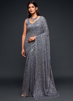 Dominate any party or event with this premium grey sequins and thread designer saree. Made with luxurious georgette fabric, it will make you stand out from the crowd. Perfect for receptions and festive occasions, it also makes a great gift for your girlfriend. Take on the challenge and embrace the adventure of looking stunning and confident! The unstitched blouse can be customized upto 42 inches. Do Note: All the accessories shown are for styling purpose only. Slight color variation may occur du Sequins Saree, Sequence Saree, Sequin Saree, Grey Saree, Party Sarees, Red Lehenga, Party Wear Saree, Patiala Salwar, Saree Design