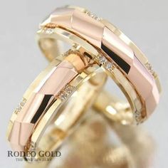 two gold wedding bands with diamonds on them