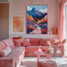 a living room with pink couches and paintings on the wall above them, along with other furniture