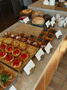 an assortment of pastries are on display at the buffet table for people to eat