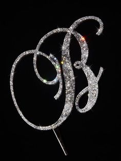 a sparkle monogrammed cake topper on a black background