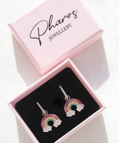 Rainbow and Clouds Earrings These cute rainbow and clouds earrings will definitely brighten up your mood on a rainy day! Their gorgeous colors will add a precious touch to your daily outfits and bring you compliments here and there. They are also a perfect gift for your loved ones as they are presented in a beautiful pink gift box. But, you can always spoil yourself too! Features: * These earrings are sold in pairs. * They are made of 925 Sterling Silver Packaging: You will get your jewelry in a Rainbow Hypoallergenic Earrings As Gift, Rainbow Hoop Earrings With Ear Wire For Gift, Rainbow Hoop Earrings With Ear Wire As Gift, Rainbow Crystal Drop Earrings For Gift, Rainbow Drop Earrings As A Gift, Rainbow Drop Earrings For Pierced Ears, Hypoallergenic Rainbow Hoop Earrings As Gift, Trendy Rainbow Hypoallergenic Earrings, Trendy Multicolor Crystal Earrings As Gift