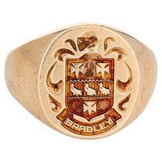 Finely detailed family crest signet ring crafted in 10 karat yellow gold. The signet ring weighs a hefty 11.1 grams. The signet mount features a Valois style arms, with a French style helmet to the top. The base of the signet mount features the family name "Bradley" (also engraved "William L Bradley"). The low rise ring (2mm - 0.15 inches) sits comfortably on the finger. The ring is in very good condition. We have not cleaned it in order to preserve the patina and collector value. Particulars: Weight: 11.1 grams Stones: N/A. Size & Measurements: The ring is a size 9.5 (sizable). The mount measures 16.5mm in length (0.64 inches) and 15mm wide (0.59 inches) rising 2mm from the finger. Metal & Hallmark: 10 karat yellow gold. The ring is hallmarked "10k" and "Heraldry House". Luxury Wedding Engraved Intaglio Ring, Luxury Vintage Men's Coat Of Arms Ring, Luxury Vintage Engraved Ring With Hallmarks, Latimer Coat Of Arms Ring, Vintage Fine Jewelry, Yellow Gold Jewelry, Ring Crafts, Modern Ring, Ring Oval