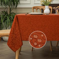 an orange table cloth with swirls on it in front of a dining room table