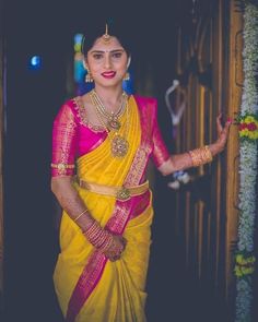 a woman in a yellow and pink sari