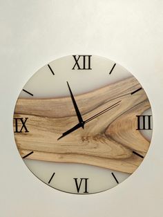 a clock made out of wood with roman numerals