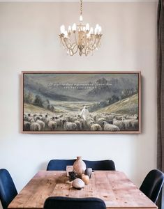 a dining room table with blue chairs and a painting on the wall above it that says,