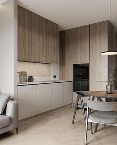 a modern kitchen and dining area with wood flooring, white walls and cabinets in an apartment