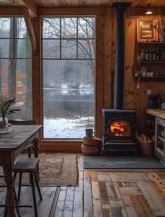 a wood burning stove sitting inside of a living room next to a table and chairs