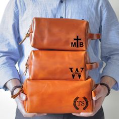 a man holding three pieces of luggage in his hands with the words mtb and w on them