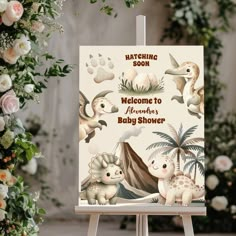 a welcome sign for a baby shower with animals and flowers in the background, on an easel