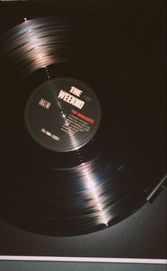 a record player's turntable sitting on top of a table with the words we need