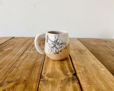 a coffee cup sitting on top of a wooden table