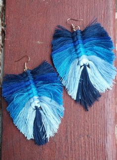 Cute handcrafted Yarn feather Earrings  Pictured as Shown  Very lightweight 2 inch drop 2 .5 inch width Cute one of a kind! Blue Bohemian Earrings With Fringe, Bohemian Blue Earrings With Fringe, Blue Fringe Earrings For Festivals, Handmade Blue Bohemian Tassel Earrings, Bohemian Blue Handmade Tassel Earrings, Adjustable Blue Feather Earrings, Artisan Blue Earrings For Summer, Blue Macrame Dangle Earrings, Blue Dangle Earrings With Macrame