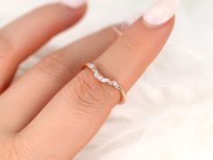 a woman's hand with a diamond ring on it