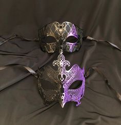 This couple's masquerade masks are great for any Venetian mask party or masquerade ball. The women's mask is made of a lightweight metal and is hand painted in a two-tone purple and black . The men's mask is also made of a lightweight metal and hand painted with purple color diamond.  Both masks have some flex and come with black silk ribbon ties attached. Women's mask size 6"W x 5"H. Men's mask size 7"W x 4.25"H. Color of masks aqua and black. Gothic Masquerade Mask For Mardi Gras, Gothic Masquerade Eye Mask For Theater, Gothic Eye Mask For Theater Masquerade, Gothic Eye Mask For Mardi Gras, Gothic Eye Mask For Theater, Purple Halloween Mask And Prosthetics, Black Masquerade Mask For Mardi Gras Costume Party, Black Masquerade Mask For Mardi Gras, Black Venetian Masquerade Mask For Carnival