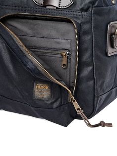 a black leather bag with zippers on it