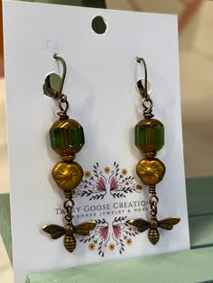 Welcome to our listing. These are a one of a kind pair of earrings using the best materials. The beads are beautiful Czech beads and the charm is a beautiful antique natural brass bee charm.  These are a unique pair of earrings that cannot be duplicated so you will have a unique piece of wearable art.  Please reach out with any questions.  Thanks for stopping by. Handmade Metal Earrings For Vintage Collection, Bronze Dangling Beads Earrings For Gift, Bronze Beaded Dangle Earrings, Nickel-free Vintage Drop Beaded Earrings, Vintage Nickel-free Drop Beaded Earrings, Bronze Earrings With Dangling Beads For Gift, Beaded Dangle Brass Earrings For Gifts, Vintage Beaded Earrings With Ear Wire As Gift, Dangle Beaded Brass Earrings For Gifts