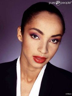 a woman with dark hair and red lipstick