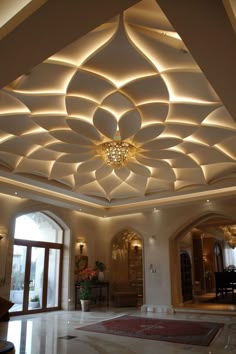 a large room with an intricate ceiling and chandelier on the ceiling is lit by lights