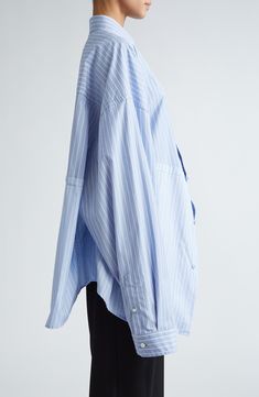 Iconically oversized, this striped button-up shirt boasts boldly dropped shoulders and an asymmetric collar. 32 1/2" front length; 30 1/2" back length (size 8US/38FR) Front button closure Asymmetric point collar Long sleeves with button cuffs Dropped shoulders 100% cotton Dry clean or machine wash, line dry Made in Italy Designer Clothing Balenciaga Shirt, Blue And White Striped Shirt, Designer Clothing Brands, Stripe Shirt, Cut Up, Asymmetrical Tops, Fabric Store, Fashion Details, Striped Shirt