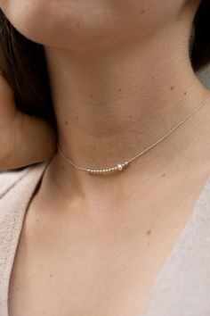 This dainty choker is hand-made of 925 sterling silver beads and a single freshwater pearl. The necklace is a perfect everyday jewelry piece. Length:   ● 35 cm with a 5 cm extension  Lengths are measured from end to end, the clasp is included in the measurements. The choker will include an additional 3 cm extension chain. Want to see more jewelry from my shop? click here: http://etsy.me/2uPuv0x ● The item will be shipped beautifully wrapped, as shown on the last picture of the listing, and ready Sterling Silver Choker, Dainty Choker, Silver Choker, Chain Choker Necklace, Chain Choker, Minimalist Necklace, Delicate Necklace, Everyday Jewelry, Sterling Silver Bead